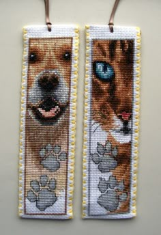 two bookmarks with dogs on them are hanging from the wall and one has blue eyes