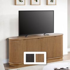 a flat screen tv sitting on top of a wooden cabinet