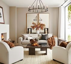 a living room with couches, chairs and a fire place in the center table