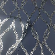 a close up view of an artistic wallpaper design with silver glitter on the surface