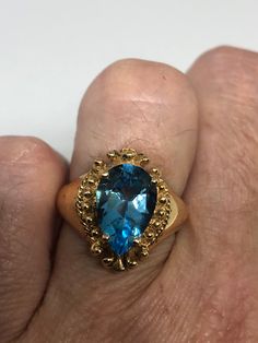 Huge great color blue topaz stone setting is handcrafted in gold finished 925 sterling silver Size 6 Can be sized, my jeweler charges $10-$20 Please ask for a quote? All rings are shipped free in the US in a nice gift box. Check out our over a THOUSAND great reviews Engraving is $4 per letter and is not always perfect depending on the piece. It can take a few days if the jeweler is busy. This is payable to Paypal Judithsltd@gmail.com Unique Gold Topaz Ring For Formal Occasions, Gold Teardrop Topaz Ring For Formal Occasions, Elegant Gold Ring With Blue Topaz, Unique Gold Topaz Ring For Anniversary, 14k Gold Topaz Ring Stamped 14k, Blue Topaz Crystal Ring For Formal Occasions, Formal Topaz Birthstone Ring With Gemstone, Unique Yellow Gold Topaz Ring For Formal Occasions, Gold Rings With Blue Topaz Birthstone