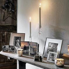 candles and pictures on a table in a room