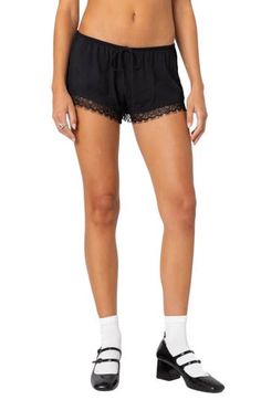 Scalloped eyelash-trim lace details the hems of these low-rise lightweight shorts topped with a drawstring waist. Drawstring waist 100% rayon Hand wash, dry flat Imported Black Pajama Shorts For Summer Daywear, Black Short Bottoms With Lace Trim, Black Lace Trim Short Bottoms, Black Lounge Bottoms With Lace Trim, Lace Bottoms For Summer Loungewear, Lace Loungewear Shorts, Black Bottoms With Lace Trim, Spring Lace Shorts For Loungewear, Black Lace Trim Shorts For Summer