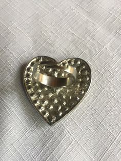 "Pave clear rhinestone heart shaped ring, very 70s. The heart is about 1.625 wide and tall. Classic cocktail ring, retro elegant. Size 8.5, but it's adjustable so it would fit to about size 10.5 comfortably. Could also be used as a scarf ring. Please know that if you don't like the way the ring fits, you can return it; you pay for the shipping, but there's no restocking fee or questions asked, I just refund the ring's cost. Also, please take a look at my storefront at: https://www.etsy.com/shop/ Metal Heart Ring As Gift, Metal Heart Ring For Valentine's Day, Heart-shaped Metal Ring Gift, Metal Rings For Anniversary On Valentine's Day, Heart Shaped Metal Rings For Valentine's Day, Heart-shaped Metal Rings For Valentine's Day, Silver Heart Shaped Metal Ring, Heart-shaped Metal Rings For Anniversary, Vintage Silver Heart Ring For Valentine's Day