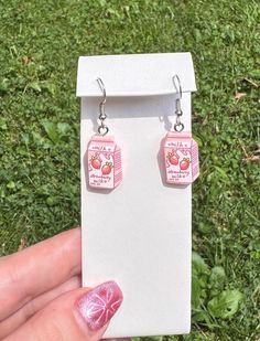 🍓🥛Handmade funky strawberry milk drop earrings🍓🥛 ❤️Products are handmade so there may be minor flaws. Colors may vary slightly due to lighting and screen differences.❤️ Quirky Handmade Pink Earrings, Quirky Pink Jewelry Gift, Quirky Pink Jewelry As A Gift, Cute Strawberry Print Earrings For Gifts, Sweet Handmade Dangle Earrings, Pink Strawberry Print Earrings For Gift, Pink Strawberry Print Earrings As Gift, Cute Pink Jewelry With Strawberry Print, Cute Pink Strawberry Print Jewelry