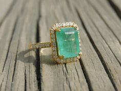 18k Emerald Cut Natural Emerald Diamond Ring - Women 18K Gold Gift Ring - 4.70 Carat Emerald Ring - Perfect Engagement Gift - May Birthstone GEMSTONE DETAILS : ✦ Gemstone : Natural Zambia Emerald ✦ Gemstone Size : 8.50 width and 10 mm length ✦ Gemstone Shape : Emerald Cut ✦ Number of Gemstones : 1 ✦ Gemstone Weight : 4.70 Carat ✦ Gemstone Grade : AAA DIAMOND DETAILS : ✦ Diamond Type : Natural ✦ Diamond Size : 1.70 mm and 1.5 mm ✦ Diamond Color : G-H ✦ Diamond Clarity : Slightly included ✦ Diamon Emerald Ring With Pave Setting For Gift, Emerald Ring With Pave Setting As A Gift, Gold Emerald Rings With Pave Setting, Exquisite Emerald Ring With Pave Setting For Wedding, Emerald Wedding Jewelry With Pave Setting, Exquisite Wedding Emerald Ring With Pave Setting, Dazzling Yellow Gold Emerald Ring Gift, Gold Emerald Ring With Pave Setting As Gift, Gold Emerald Cut Ring With Pave Setting