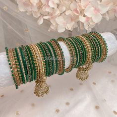 2 Large stacks of luxurious Antique Gold & green bangles, finished with our Neha crystal jhumka bangle in the centre of each stack.  Perfect for reception brides or those wanting to make a statement. Ready to Ship! Green Bangles Set For Bride, Green Bangles Set, Orange Bangles, Green Bangles, Traditional Bangles, Bridal Jewelry Sets Brides, Reception Bride, Glass Bangles, Fancy Jewellery Designs