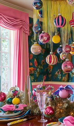 Kitsch Christmas decor doesn’t have to mean chaos. The secret to pulling off a kitsch Christmas vibe that’s chic and fun? Start with a theme—like retro Santas, candy-inspired ornaments, or funky animal figurines—and stick to a tight color palette of no more than 3 main colors. Balance all that boldness with neutral backdrops and elegant accents like gold candlesticks or velvet ribbons. With a few statement pieces and strategic placement, you’ll go from kitsch to classy in no time. Learn how to style your kitschy decor like a pro and make this Christmas your most stylish yet. Read our article now to discover how to decorate your home with kitsch Christmas styles this Holiday. Eclectic Holiday Decor, Kitschy Christmas Diy, Midcentury Christmas Decor, Christmas Store Windows, Vintage Outdoor Christmas Decorations, Christmas Mindfulness, Palm Springs Christmas, Funky Christmas Decor, Colourful Christmas Decorations