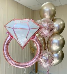 a bunch of balloons that are in the shape of a ring with a diamond on it