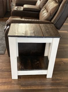 a living room with a couch, chair and end table in the middle of it