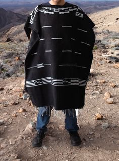 Material: Acrylic WoolColor: BlackStyle: Mexican Design: Clint EaswoodSize:Length: 192cm (75")Width: 112 cm (44")It refers to the total measurements of the poncho when it is fully open (like a blanket). Description: MEXICAN PONCHO Discover the iconic Mexican Poncho Clint Eastwood made famous. This timeless garment has been a symbol of rugged style and effortless cool. Crafted with authentic Mexican craftsmanship, our Mexican Poncho captures the essence of Clint Eastwood's classic western films.