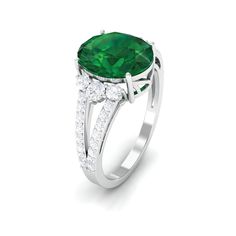 Product Details The timeless elegance of this Emerald Engagement Ring is sure to make your moment memorable. Features 8X10 mm oval-shaped created emerald artfully set in prong setting complimented by round petite moissanite, adding an extra hint of sparkle to the emerald ring. Take her breath away with this green emerald ring crafted with a split shank that embraces the overall brilliance of the engagement ring. This stunning split shank ring carries a weight of 4 carats. Celebrate special momen Emerald Solitaire Engagement Ring, Split Shank Engagement Ring, Split Shank Engagement Rings, Shank Engagement Ring, Green Emerald Ring, Split Shank Ring, Lab Created Emerald, Ring Crafts, Emerald Engagement Ring