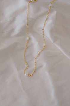 An effortless piece that's perfect for everything. Pearls are believed to be a calming, centering gem that nourishes integrity, faith, and loyalty. They are also symbols of femininity, helping one connect with their inner goddess or feminine energy.This necklace features alternating small and medium pearls that are hand-set onto a shimmering chain. The pearls are slightly irregular in shape and may contain natural natural grooves. Chains are available in sterling silver or 14k gold filled.PEARL Pearl White Clavicle Chain Jewelry For Everyday, Pearl White Jewelry With Adjustable Chain, Pearl White Jewelry With Adjustable Chain For Everyday, Gold Pearl Necklace With Spiritual Charm, Spiritual Gold Pearl Necklace With Pearl Charm, Spiritual Gold Jewelry With Pearl Charm, Spiritual Gold Pearl Necklace With Charm, Gold Pearl Dainty Chain Necklace, Adjustable Gold Pearl Chain Jewelry