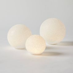 three white balls sitting next to each other