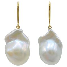 Indulge in the alluring grace of our Iridescent White Baroque Pearl Drop Earrings with 18K Yellow Gold French Hooks, crafted to captivate and inspire. These remarkable earrings feature stunning Freshwater Cultured Baroque Pearls, boasting a brilliant white hue that exudes timeless elegance. Each earring showcases a single Iridescent White Baroque Pearl with a combined weight of 37.50 carats. The pearls mesmerize with their distinct shapes and mesmerizing luster, measuring approximately 20.33mm x Luxury High Luster Yellow Gold Earrings, Luxury Briolette Pearl Earrings, Formal Briolette Earrings With High Luster, High Luster Briolette Earrings For Formal Occasions, Exquisite Yellow Gold Earrings With High Luster, Formal High Luster Briolette Earrings, Luxury Baroque Earrings For Formal Occasions, Luxury Baroque Formal Earrings, Luxury Yellow Gold Drop Pearl Earrings