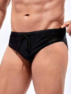 Elevate your beach attire with our Mesh Waist Swim Brief, a must-have addition to your swimwear collection. In classic black, this brief features a plain pattern and an eye-catching contrast mesh detail, adding a modern edge. The medium-stretch fabric ensures a comfortable fit, allowing you to enjoy your time in the water. Features: Color: Black Pattern Type: Plain Details: Contrast Mesh Type: Briefs Fabric: Medium Stretch Material: Fabric Care Instructions: Hand wash, do not dry clean Size Char Black Beachwear Swim Trunks For Pool, Black Nylon Swim Trunks For Poolside, Black Nylon Swim Trunks For Beach Season, Black Nylon Swim Trunks For Swimming, Black Nylon Tie-side Swimwear, Black Tie-side Nylon Swimwear, Black Swim Trunks For Poolside And Beach Season, Black Moisture-wicking Swim Trunks For Poolside, Black Nylon Swim Trunks For Beachwear