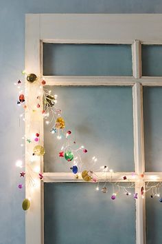 an old window is decorated with christmas lights