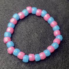 Material: Clear string Color: Pink and blue beads Type: Bracelet Style: Casual Blue Bangle Jewelry With Large Beads, Pink Hand-strung Bangle Stretch Bracelet, Pink Stretch Bracelet With Colorful Beads For Friendship, Blue Friendship Bracelet With Colorful Round Beads, Blue Beaded Stretch Bangle Bracelet, Pink Hand-strung Beaded Bracelets For Friendship, Blue Jewelry With Colorful Beads For Friendship, Friendship Pink Hand-strung Beaded Bracelets, Handmade Light Blue Beaded Bracelets