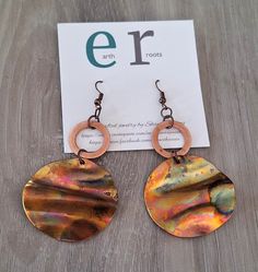 These boho style earrings feature 1.5" copper blanks that have been fire painted with a propane torch to bring out the different colors in the metal when heated. NOTE:  Certain types of lighting will bring the colors out more than other types of lighting. They are finished with a smaller copper hoop.  They measure just under 3" in length. They will ship in a gift box via USPS with tracking info provided,. Artsy Nickel-free Copper Earrings, Artsy Brown Copper Jewelry, Artistic Copper Earrings With Patina, Hand Painted Copper Bohemian Earrings, Bohemian Hand Painted Copper Earrings, Rust-colored Soldered Copper Earrings, Hand Painted Copper Artsy Earrings, Artisan Orange Copper Earrings, Hand Painted Artsy Copper Earrings