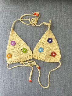 Handmade one of a kind crochet swim suit  top. The perfect yellow colored yarn detailed with bright flowered embellished with pearls is perfect for summer! Wear as a swimsuit or to a festival for a fun and unique look!                   Fits XS/S Multicolor Crochet Swimwear For Summer, Summer Crochet Lace Top Made Of Yarn, Summer Crochet Swimwear, Spring Poolside Crochet Summer Top, Spring Poolside Crochet Top, Beachy Crochet Trim Swimwear For Spring, Bohemian Crochet Swimwear For Summer, Bohemian Crochet Lace Swimwear For Summer, Beachy Swimwear With Crochet Trim For Spring