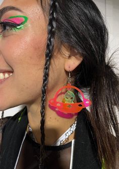 Take off on an intergalactic adventure with the Space Ranger Earrings! The ultimate accessory for those who have a passion for all things extraterrestrial. Carefully handmade with high-quality materials, these earrings are sure to last through every dance and festival adventure. - Made with lightweight acrylic for comfortable wear- Alien is UV-reactive green you can get the UFO ship either black glitter or uv reactive pink- Earring hooks are stainless steel, nickel-free, and hypoallergenic- Rubber backing included to keep things secure while you dance the night away! Trendy Pierced Earrings For Festivals, Trendy Single Earring For Festivals, Handmade Rave Jewelry For Party, Trendy Festival Earrings With Ear Wire, Adjustable Funky Earrings For Festivals, Fun Dangle Earrings For Festival, Fun Dangle Earrings For Festivals, Rave Jewelry For Music Festival With Adjustable Fit, Unique Hoop Earrings For Party