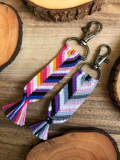 a keychain with a multicolored chevron pattern and tassels