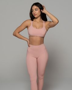 Stay supported while you sweat with this Stardust Pink Sports Bra. Featuring a solid color design, scoop neckline and strappy back - it's so stylish. Made from high-quality nylon-spandex material, it is soft and comfy. Plus, integrated quick-dry technology keeps you cool and dry. Wear with matching bottoms and fresh kicks for a simple but chic look. We are obsessed! Nylon T-back Activewear For Yoga, Moisture-wicking Cross Back Activewear, Solid Moisture-wicking Cross Back Activewear, Sports Bra With 4-way Stretch For Light Exercise, Sports Bra For Light Exercise With 4-way Stretch, Cross Back Activewear With 4-way Stretch, Solid Color Cross Back Activewear With 4-way Stretch, Solid Color Activewear With 4-way Stretch And Cross Back, Nylon Activewear With Built-in Bra And Strappy Back