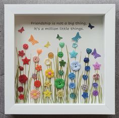 a shadow box with buttons and flowers in it that says, friends is not a big thing it's a million little things