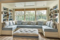 a living room filled with furniture next to a window covered in lots of windowsills