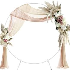 a wedding arch decorated with flowers and feathers