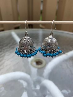 "I have accented a filigree jhumka base liberally with blue beads. These are an adornment to your earlobes. Pair this with any outfit you can dream of, you will not be disappointed.  These are famous in Jaipur, Rajasthan and Lucknow, filigree jhumkas are a rage and works well with any outfit. Total length is 1.5\". Metal - Sterling Silver. Please feel free to ask me for more pictures or questions. Thank You for Shopping Jhumkas they are Ancient, Elegant, Opulent and Regal!" Bohemian Beaded Danglers For Festive Occasions, Blue Dangle Jhumkas For Festive Occasions, Blue Tilla Jhumkas For Festivals, Blue Tilla Jhumkas For Gift, Blue Jhumkas With Tilla For Festivals, Blue Bollywood Jewelry With Latkans, Blue Jhumkas For Festive Occasions, Blue Jewelry With Latkans For Diwali, Blue Jhumkas With Latkans For Diwali