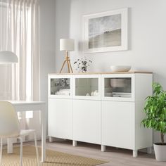 a white dining room with a table and chairs