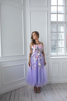 Feel like a fairy tale princess in our dreamy purple floral dress!  With delicate flower appliques, a flowy midi length,  and lace detailing on the back, this dress is perfect for weddings,  proms, or photo sessions.  And the best part? Bow ties on the shoulders add a touch of romance  and playfulness to this enchanting dress. Message me for any kind of customizations. Purple Princess Dress For Prom Season, Purple Bridesmaid Dress For Prom Season, Purple Bridesmaid Dress For Prom, Lavender Midi Party Dress, Lavender Sleeveless Dress For Wedding, Sleeveless Lavender Dress For Wedding, Lavender Dress For Spring Homecoming, Lavender Midi Dress For Wedding, Spring Prom Midi Dress With Tulle Skirt