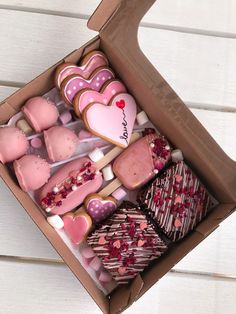 a box filled with lots of heart shaped cookies