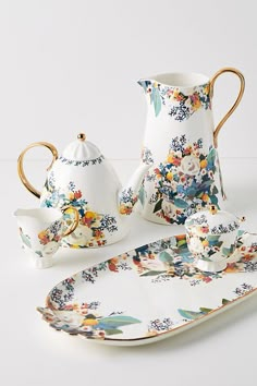 a porcelain tea set with flowers on it