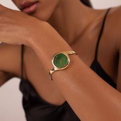 Claire's unique ring-like shape and hidden crown make it look more like a bracelet than a watch. The genuine jade dial pairs beautifully with the polished yellow gold bangle. Material: Stainless Steel Finishing: 23k Gold Plating Dial: Genuine Jade Movement: Swiss Ronda Quartz Glass: Hardened Mineral Crystal Water Resistance: 3 ATM Vintage Watches Women, Crystal Water, Yellow Gold Bangle, Bangle Watches, Jade Bangle, Classy Jewelry, Watches Unique, Jewelry Lookbook, Gold Bangle