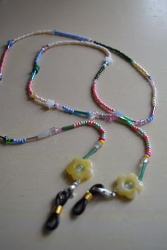 Handmade beaded glasses chain with pastel daisy flower beads. These chains are cute, comfortable, and lightweight. The glasses hoops are detachable which can be used also for sunglasses. All of these chains are uniquely made. These are for those who love pastel, soft eye wear accessories. The chain is elastic and stretchy. This chain is 28.25 inches long. Handmade Pink Glasses Chains For Summer, Daisy Glasses, Beaded Sunglasses Chain, Beaded Glasses Chain, Beaded Glasses, Beaded Sunglasses, Beaded Daisy, Pastel Beads, Soft Eyes