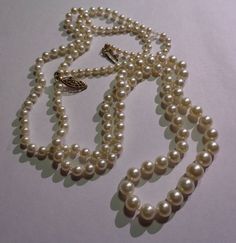 Pearl necklace is a 1940s antique faux fashion 36" opera length graduated glass pearl necklace, with silk knotted pearls and a gold filled fish hook clasp. Vintage antique long knotted pearl necklace from my Mother's estate jewelry collection, is from the the 1940s and features 36 inches of silk knotted fashion or glass pearls in an opera length.These vintage traditional warm white faux glass pearls range from 3.5mm in size at the back and they graduate to 7.7mm at the largest center pearl.The n Formal Antique Pearl Drop Necklace, Vintage Pearl Necklace With Pearl Charm For Formal Occasions, Classic Single Strand Pearl Necklace For Evening, Formal Long Single Strand Pearl Necklace, Vintage Pearl Drop Necklace For Formal, Vintage Formal Necklace With Pearl Charm, Vintage Pearl Drop Necklace For Formal Occasions, Formal Vintage Necklace With Pearl Charm, Vintage Long Pearl Necklace