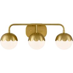 three light brass finish bathroom fixture with white glass balls on the bottom and gold metal arms