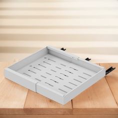 an empty white tray sitting on top of a wooden table