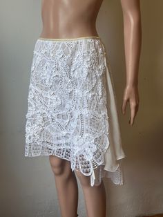 Easy breeze wrap dressy skirt. Hand Made Lace Embellished With Ribbons and 100% Silk Chiffon. Lace is 100%pure cotton.   The skirt is uneven , but we can still  call it short skirt.  Because it's a wrap skirt , can fit many sizes, you can wear it at waist or below waist, over  three inches for overlap. The whole skirt is lined with Off White Silk Chiffon. Opened on the sides but the open is  well covered by the chiffon ruffles. Measurements- Waist----------  overlap for 28,32, and 33in Length---------- Left side 23in                            Right  side 21in Back-   24in Summer Party Skirt With Lace Trim, Bohemian Fitted Dress With Asymmetrical Skirt, Fitted Bohemian Dress With Asymmetrical Skirt, Fitted Bohemian Wrap Skirt For Summer, Fitted Cotton Wrap Skirt For The Beach, Fitted Cotton Wrap Skirt For Beach, Fitted Cotton Beach Wrap Skirt, White Asymmetrical Relaxed Dress, White Asymmetrical Dress With Relaxed Skirt