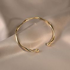 ✦ Our Simple Gold Wave Open Cuff Bangle Bracelet is a dainty and stylish accessory perfect for everyday wear. Crafted from high-quality materials and plated with a shiny gold finish, this bracelet features a unique wave design and an open cuff for comfortable wear. It makes a thoughtful gift for her, best friend or as a couple bracelet. ----------- DETAILS ------------ Diameter: 6.2cm- Size: Adjustable - Color: Gold/ Silver- Materials: Alloy, Gold Plating- SKU: HB637