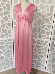 This is a sweet v neck sleeveless satin nylon nightgown with a plaited tie under the bust and ties at the back. It is new old stock with tags by Jillray made in Australia in the 60s or 70s. It is a long below knee length  Condition is very good  Bust 96cm Length shoulder to hem 142cm Summer Satin V-neck Nightgown, Feminine Pink V-neck Nightgown, Spring Sleeveless Satin Nightgown, Sleeveless Satin Nightgown For Spring, Spring Evening V-neck Nightgown, Satin V-neck Summer Nightgown, Spring Evening V-neck Sleepwear, Pink V-neck Nightgown For Sleep, Pink Satin V-neck Sleepwear