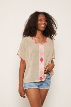 This is it. The perfect post-yoga-gotta-run-to-a-Zoom-meeting top. The hand-embroidered design and colorful details on the neckline and sleeves offer a simple boldness that radiates joy and confidence. Inspired by traditional Habesha Kemis design, this top is a casual staple in any boho chic closet. About the Maker: Menby DesignFounded by Menbere Alemayehu, a native of Ethiopia committed to preserving traditional Ethiopian hand-weaving and hand-embroidery by introducing the techniques into piece Traditional Tops, Chic Closet, Ethiopian Women, Habesha Kemis, Post Yoga, Short African Dresses, Desert Rose, Embroidered Design, African Dress