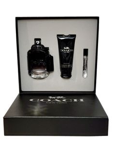 an open black box containing three items including a perfume bottle and two silver tubes in it