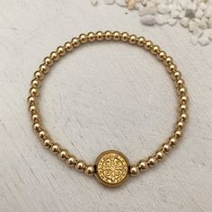 This classic piece is a jewelry lover's must have! Sure to become your new favorite everyday staple. 3mm quality gold fill beads strung on super strong stretch cord. 11mm double sided St Benedict coin charm. Perfect for creating layered looks or wear one alone. Dating back over 1,000 years, the Benedictine cross is one of the most powerful symbols of divine protection in the Christian world. Carry this cross with you at all times as a symbol of protection over you, your loved ones and all of you