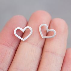 "These heart earrings are a special piece for a romantic nature and a great gift for her on a special occasion. They are great for everyday use and so lightweight, that you'll never feel them. The earrings are approx. 10 mm (3/8\") high. Choose material for the earrings (sterling silver or 9k gold). The earrings are made to order, so it'll take up to 5 days to ship them. You will receive them gift wrapped for no additional charge." Delicate Sterling Silver Earrings For Mother's Day, Minimalist Hypoallergenic Heart-shaped Jewelry, Fine Jewelry Heart Pendant Earrings As Gift, Fine Jewelry Heart Pendant Earrings For Gift, Sterling Silver Double Heart Earrings, Elegant Hypoallergenic Heart Earrings For Her, Elegant Hypoallergenic Heart Earrings Gift For Her, Sterling Silver Open Heart Earrings, Heart Earrings As Mother's Day Gift