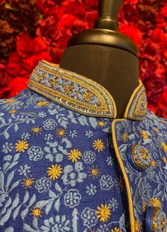 A regal blue sherwani adorned with intricate floral embroidery in gold and silver tones. The high-collared design and detailed buttons exude sophistication, making it perfect for weddings and grand celebrations. The luxurious fabric and rich embroidery make this sherwani a statement piece for any groom or special occasion. Key Features: Color: Royal blue with gold and silver floral embroidery. Design: High-collared with ornate buttons. Fabric: Rich, textured fabric for a luxurious feel. Occasion Designer Blue Cutdana Kurta, Designer Blue Kurta For Transitional Seasons, Designer Blue Kurta With Intricate Embroidery, Designer Blue Traditional Wear With Dabka Work, Traditional Blue Nehru Jacket With Intricate Embroidery, Designer Blue Nehru Jacket With Traditional Drape, Designer Blue Traditional Wear For Reception, Designer Blue Sets With Dabka Detailing, Designer Blue Sherwani With Dabka Work