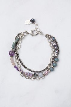 Experience the beauty and versatility of the Reflections Collection. Each piece is thoughtfully handcrafted using carefully chosen materials. This multistrand bracelet measures 7.5-8.5" and is completed an antique silver plated brass extender chain and lobster claw clasp. Elevate your style with Reflections. Antique Silver Plated Brass (lead and nickel free) Amethyst, Blue Lace Agate, Pearl 7.5-8.5", adjustable with antique silver plated brass lobster claw clasp We hand select our natural materi How To Style Pearls, Floyd Va, Multistrand Bracelet, Pearl Amethyst, Multi Strand Bracelet, Beaded Jewelry Patterns, Blue Lace Agate, Lace Agate, Jewelry Patterns