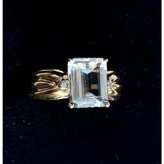 This is part of Chairish’s Fine Jewelry assortment.  DESIGNER CLYDE DUNEIER, Aquamarine & Diamond 14k Yellow Gold 2.7 Carat Ring. Ring Size: 6.5 in.  Stamped 14K, set with pale colored aquamarine. Weight of Ring: 4.9 grams Classic Diamond Gemstone With Center Stone, Anniversary Diamond Gemstones With Diamond Cut, Anniversary Diamond Cut Gemstones, Anniversary Diamond With Diamond Cut, Elegant 14k Gold Baguette Cut Topaz Ring, Elegant 14k Gold Topaz Ring With Prong Setting, Exquisite 14k Gold Rings For Formal Occasions, Classic Wedding Gemstones With Diamond Cut, Exquisite 14k Gold Baguette Cut Ring